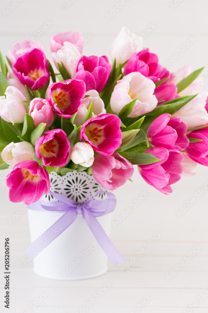 Obraz premium Pink tulip on the white background. Easter background