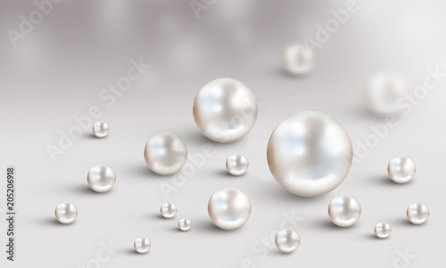 Many small and big white pearls on white and grey bokeh background