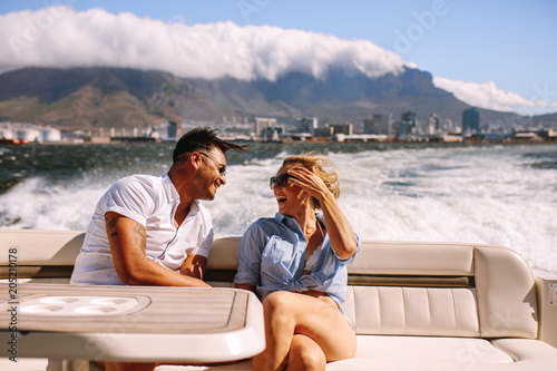 Couple traveling by a boat and laughing © Jacob Lund