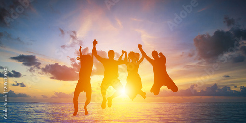 Silhouette of happy business team making high hands in sunset sky background