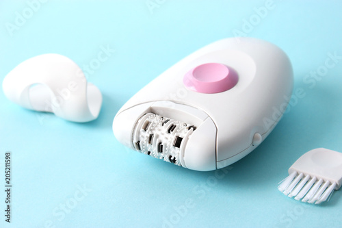 modern epilator on a colored background. minimalism. skin care, removal of unwanted hair. photo