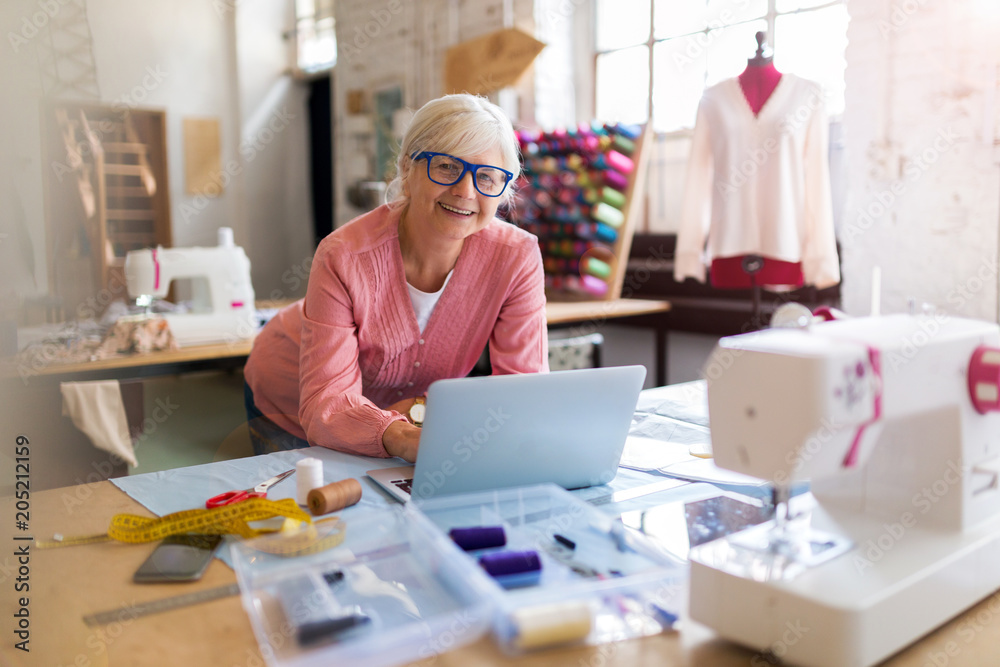 Confident senior fashion designer in her workshop
Confident senior fashion designer in her workshop