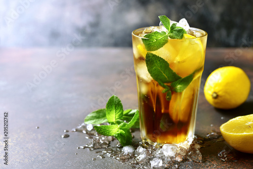 Fotografija Coold summer cocktail long island or iced tea with lemon.