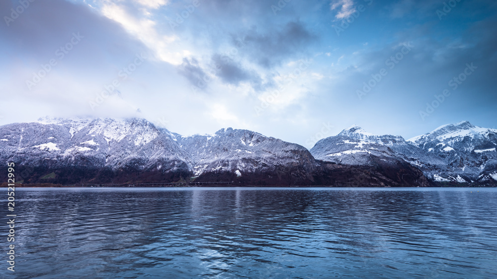 Swiss Alps. Clouds covering the mountains. Snowy peaks at sunset. Switzerland. Alps. Lake Lucerne.
