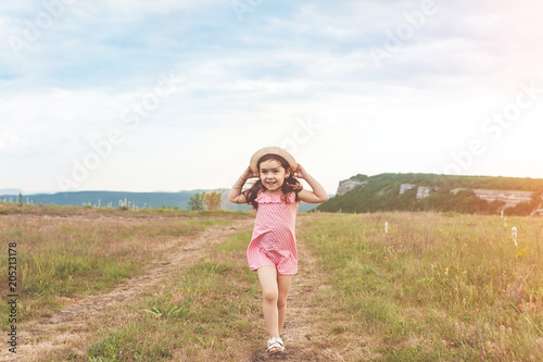 Pretty little girl jumping outdoors