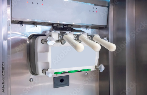 Three faucets commercial soft serve ice cream machine.
