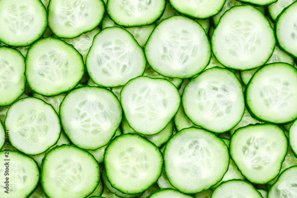 Fresh green slices of cucumber as background Fresh green slices of cucumber as background