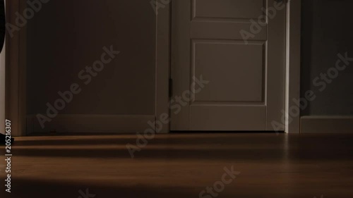 Aged man in pajamas walks on a home in the night