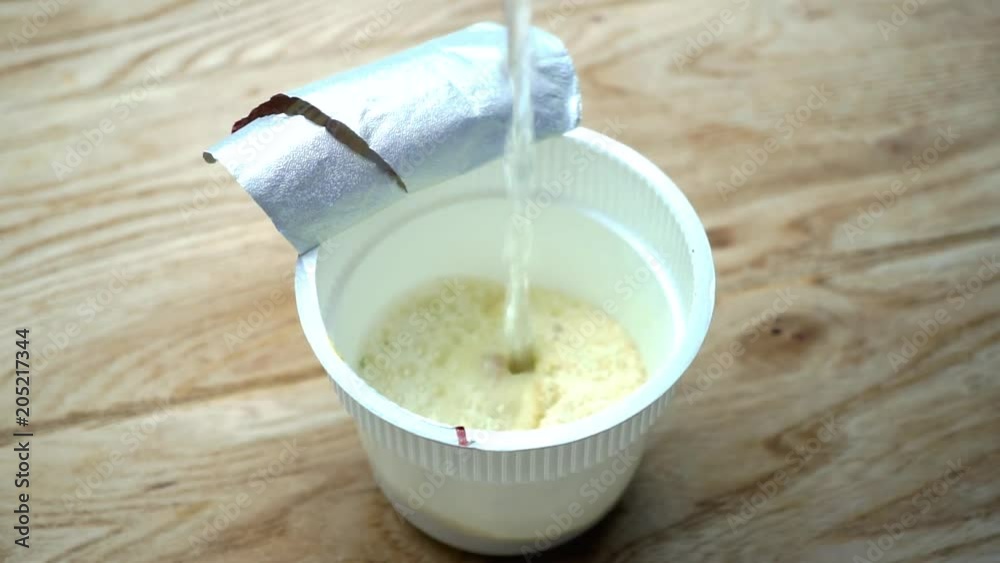 Water is added to instant potato. Macro shooting. Slow motion. Water is added to instant potato. Macro shooting. Slow motion.