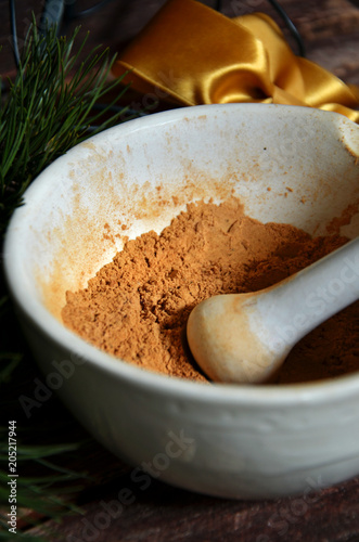 Spice for gingerbread in a mortar on wodden background