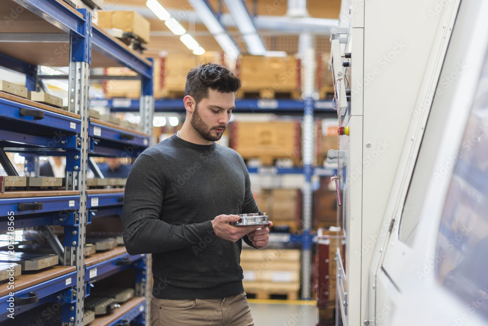 Man examining product in factory storeroom Man examining product in factory storeroom