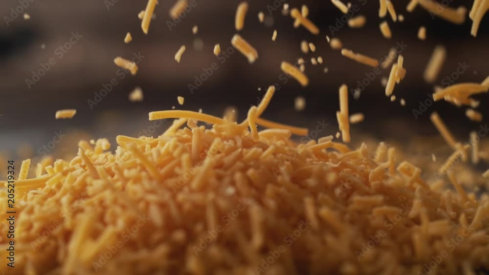 Camera follows shredded cheddar cheese. Shot with high speed camera, phantom flex 4K. Slow Motion.