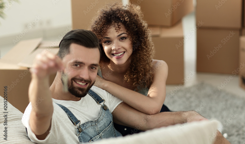 Young couple with a key to a new apartment.