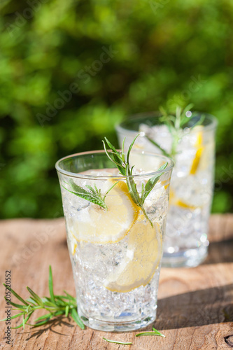 refreshing lemonade drink with rosemary in glasses