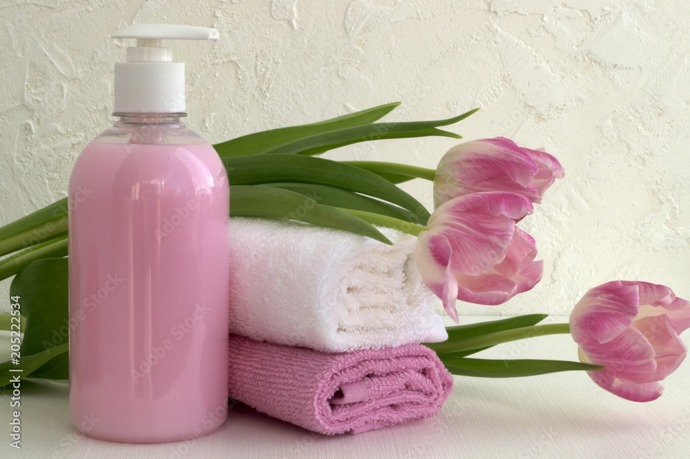 Liquid soap and two towels on a white background. Liquid soap and two towels on a white background.