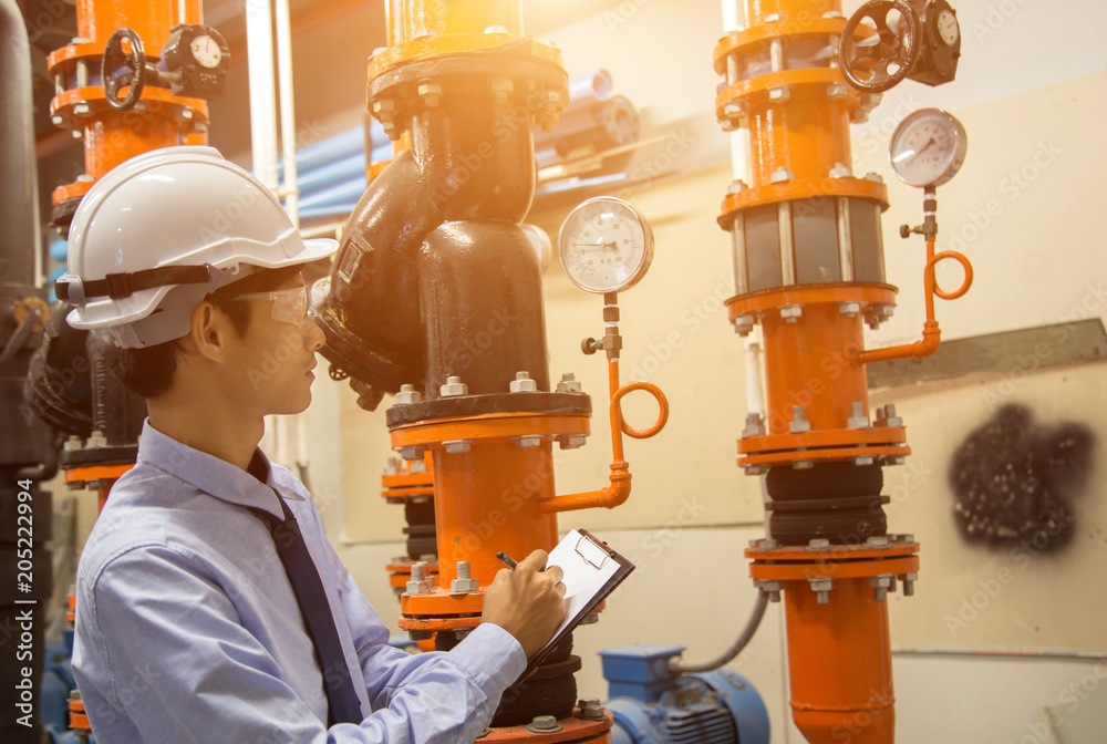Engineer checking Condenser Water pump and pressure gauge , chiller