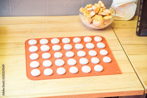 Close up pink macroons on baking dish photo