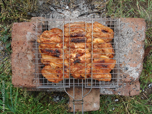 Meat on the brazier. Shish kebab in the fresh air. Grilled meat, barbecue. photo