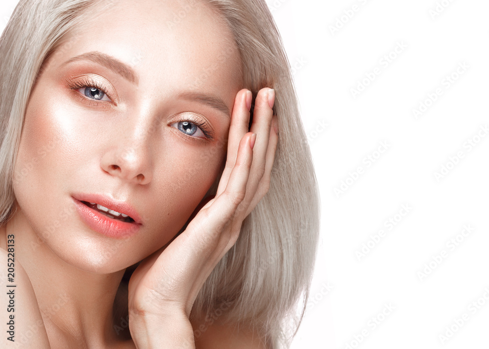 Beautiful young girl with a light natural make-up and perfect skin. Beauty face. Picture taken in the studio on a white background. Beautiful young girl with a light natural make-up and perfect skin. Beauty face. Picture taken in the studio on a white background.