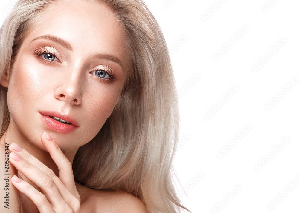 Fototapeta premium Beautiful young girl with a light natural make-up and perfect skin. Beauty face. Picture taken in the studio on a white background.