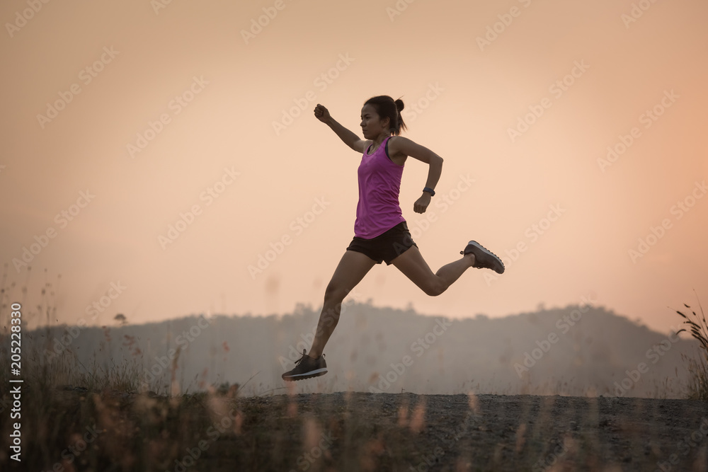 Young lady running on a rural road during sunset, sports, healthy lifestyle Young lady running on a rural road during sunset, sports, healthy lifestyle