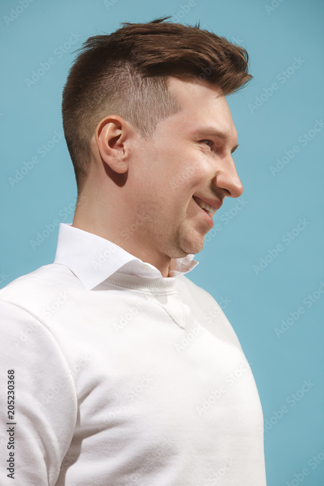 Fototapeta premium The happy business man standing and smiling against studio background.