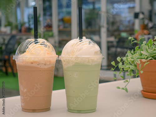 Obraz na plátně Green tea frappe and coffee frappuccino on white table