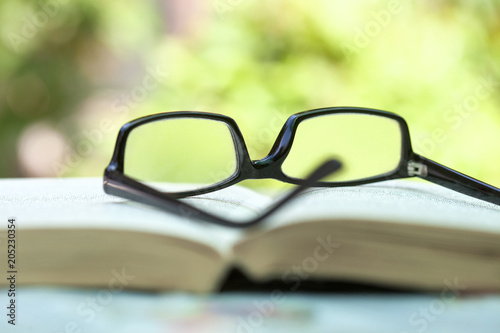 Closeup of Glasses Lying on an open Book