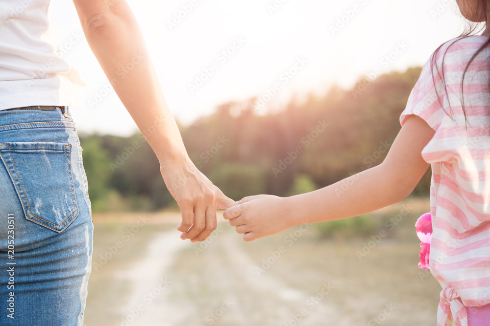 a parent holds the hand of a Children a parent holds the hand of a Children