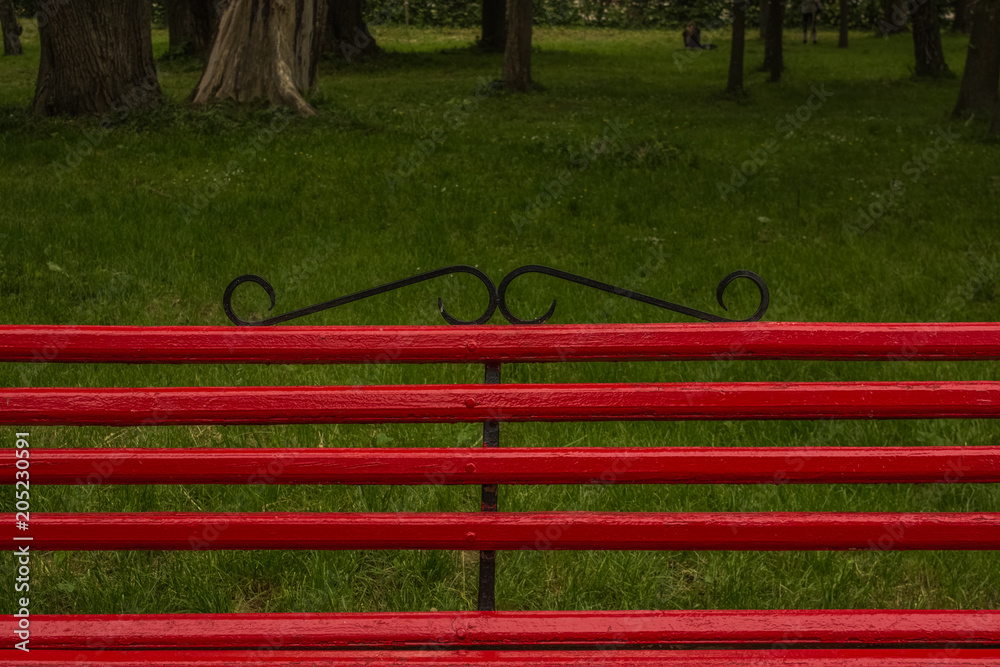red bench in outside park environment red bench in outside park environment