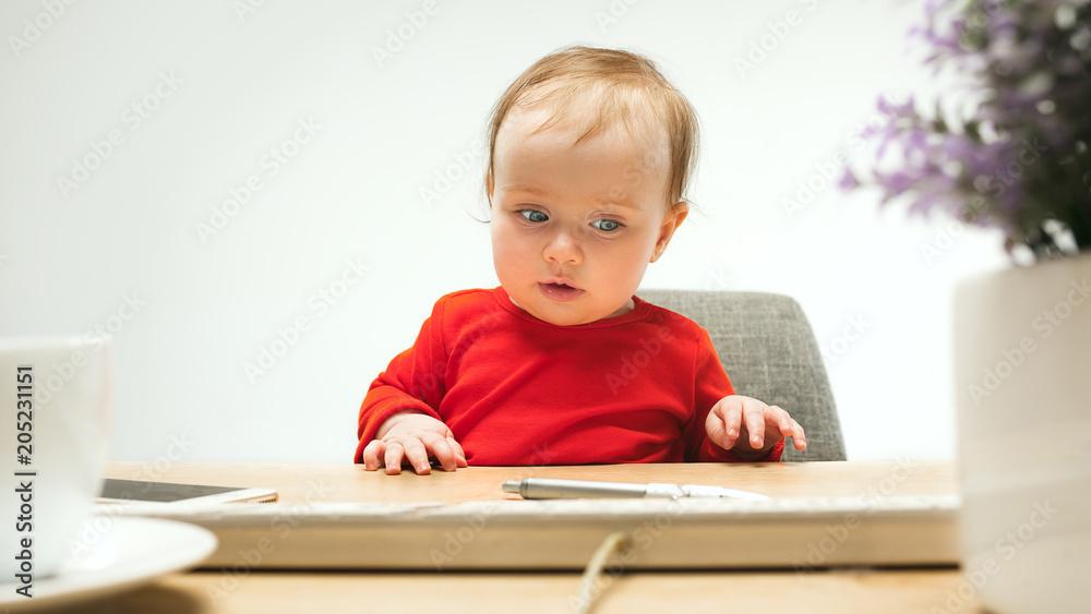 Happy child baby girl toddler sitting with keyboard of computer isolated on a white background Happy child baby girl toddler sitting with keyboard of computer isolated on a white background