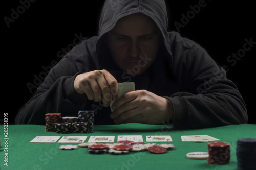 Poker table setup. High resolution image for gambling industry containning pokers chips, cards, green surface and person.