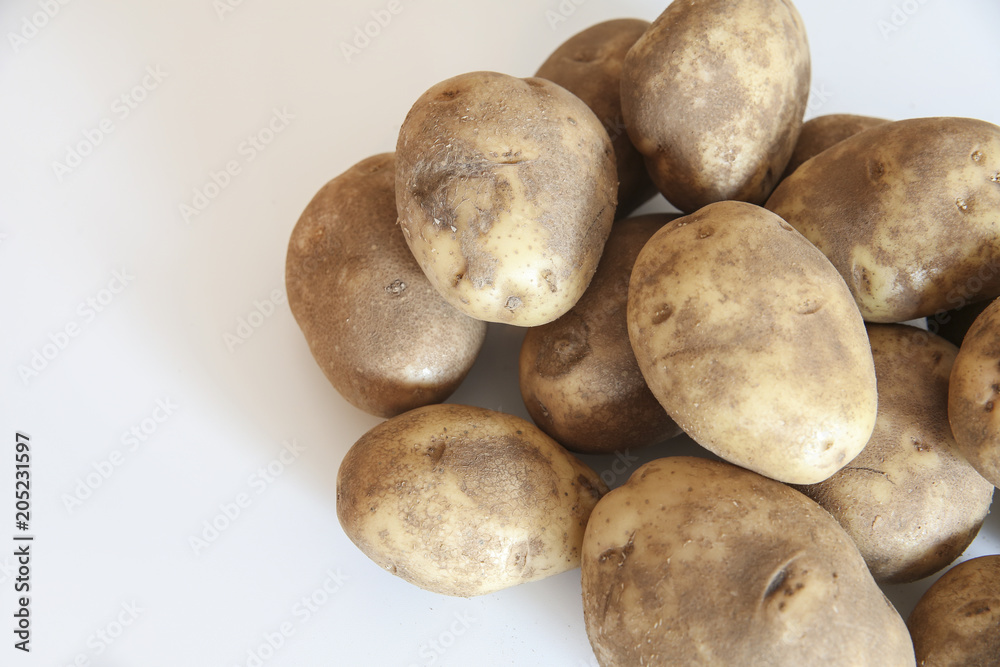 Fresh raw potatoes on a white background Fresh raw potatoes on a white background