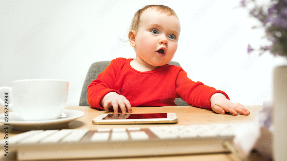 Happy child baby girl toddler sitting with keyboard of computer isolated on a white background Happy child baby girl toddler sitting with keyboard of computer isolated on a white background