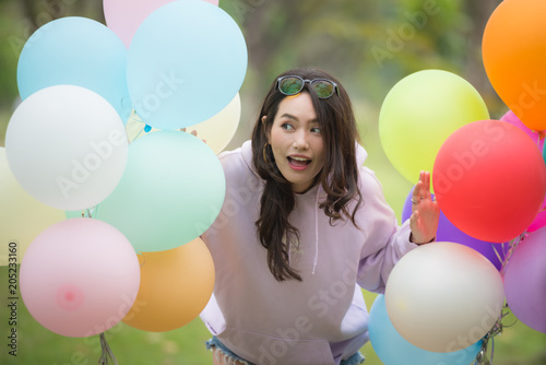 beautiful girl with balloons in park