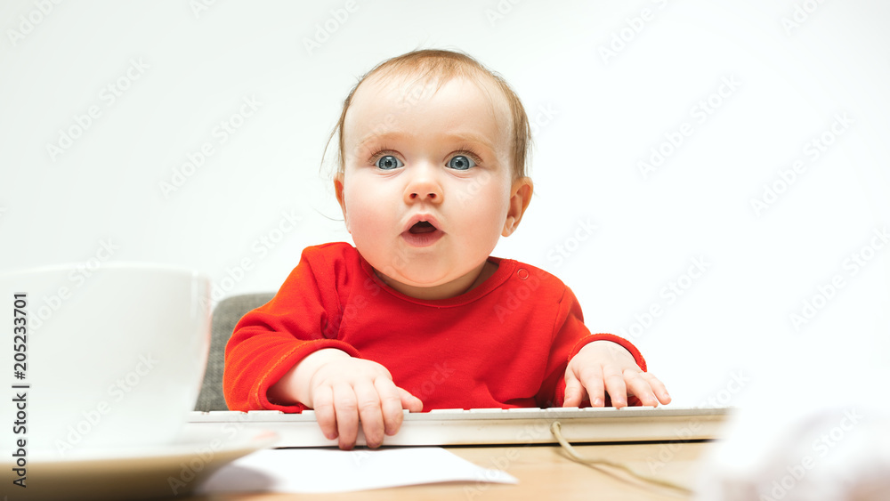 Happy child baby girl toddler sitting with keyboard of computer isolated on a white background Happy child baby girl toddler sitting with keyboard of computer isolated on a white background