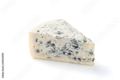 A wedge of full fat soft blue cheese isolated on white.