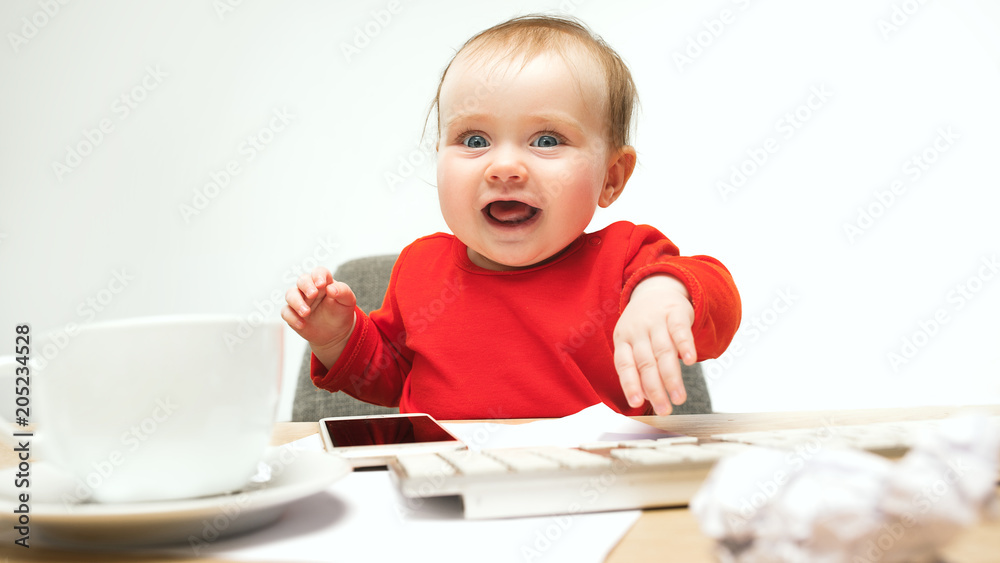 Happy child baby girl toddler sitting with keyboard of computer isolated on a white background Happy child baby girl toddler sitting with keyboard of computer isolated on a white background