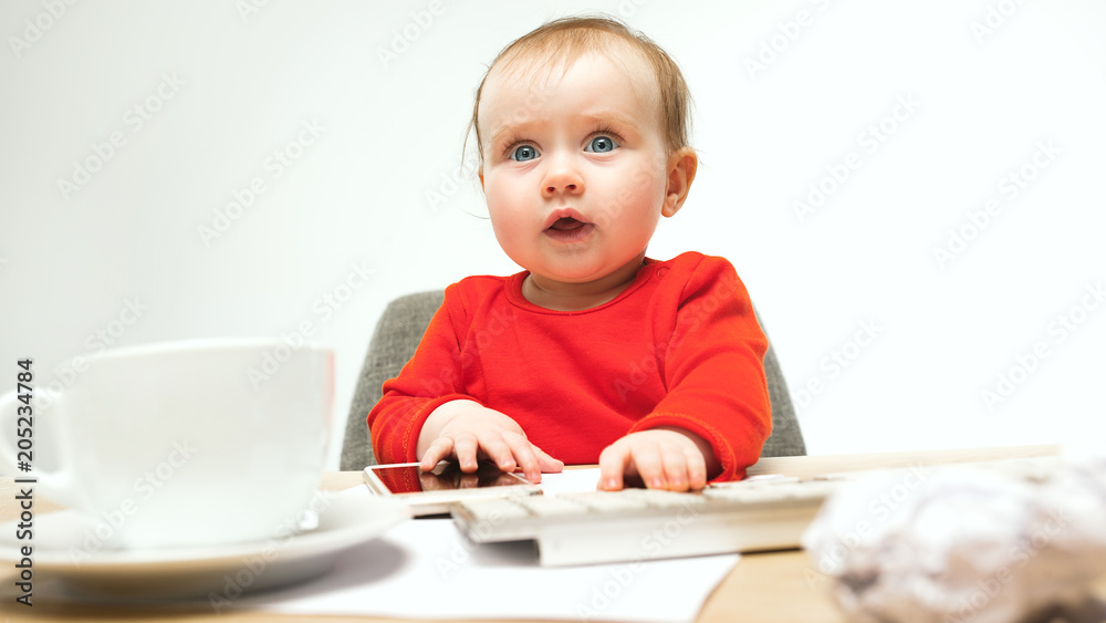 Happy child baby girl toddler sitting with keyboard of computer isolated on a white background Happy child baby girl toddler sitting with keyboard of computer isolated on a white background