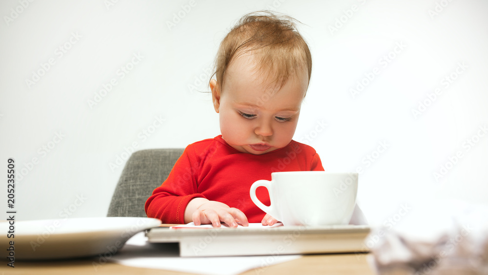 Happy child baby girl toddler sitting with keyboard of computer isolated on a white background Happy child baby girl toddler sitting with keyboard of computer isolated on a white background