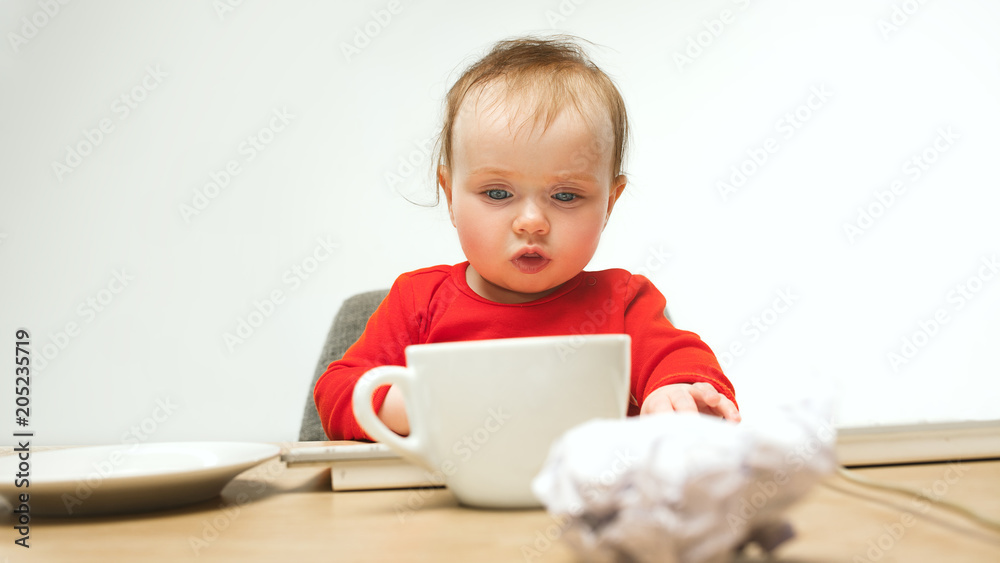 Happy child baby girl toddler sitting with keyboard of computer isolated on a white background Happy child baby girl toddler sitting with keyboard of computer isolated on a white background