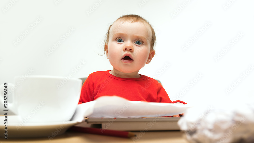 Happy child baby girl toddler sitting with keyboard of computer isolated on a white background Happy child baby girl toddler sitting with keyboard of computer isolated on a white background