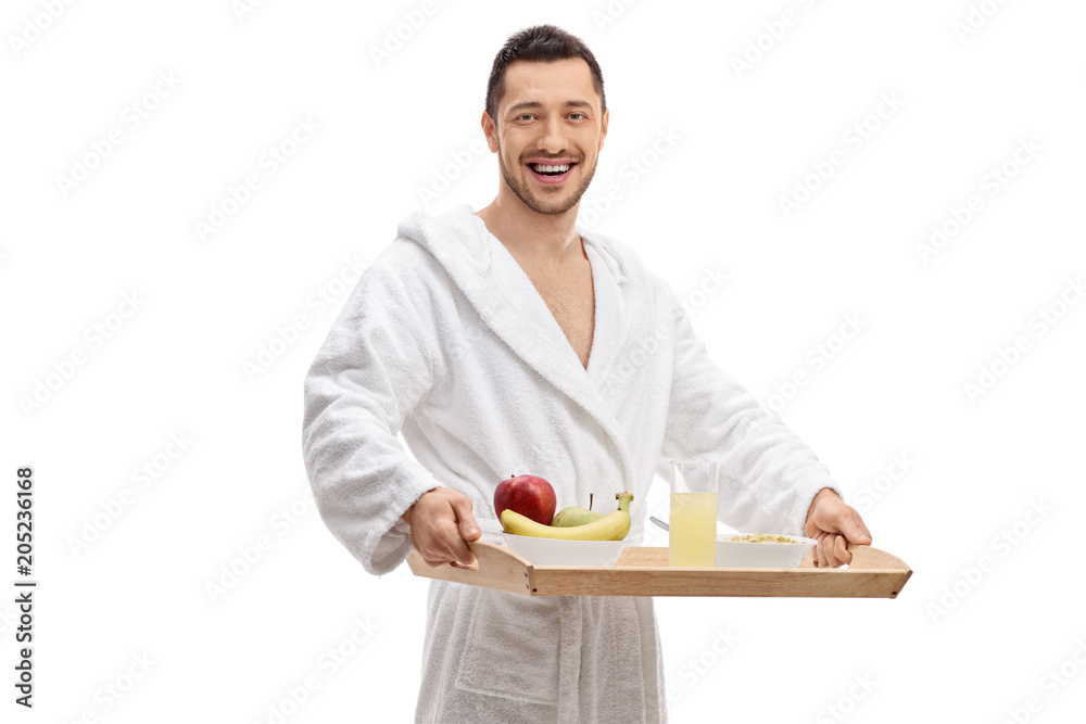 Young man in a bathrobe holding a breakfast tray Young man in a bathrobe holding a breakfast tray