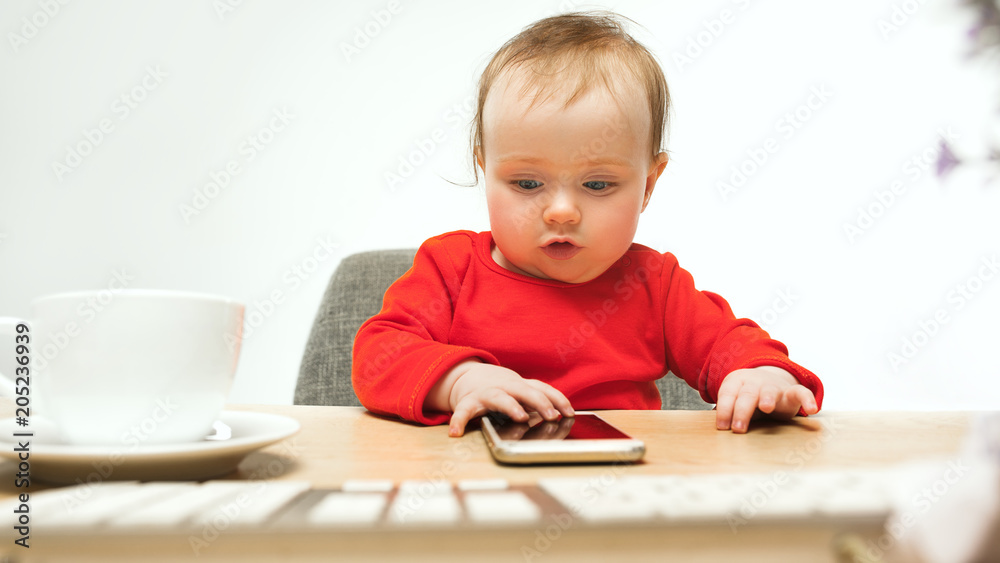 Happy child baby girl toddler sitting with keyboard of computer isolated on a white background Happy child baby girl toddler sitting with keyboard of computer isolated on a white background