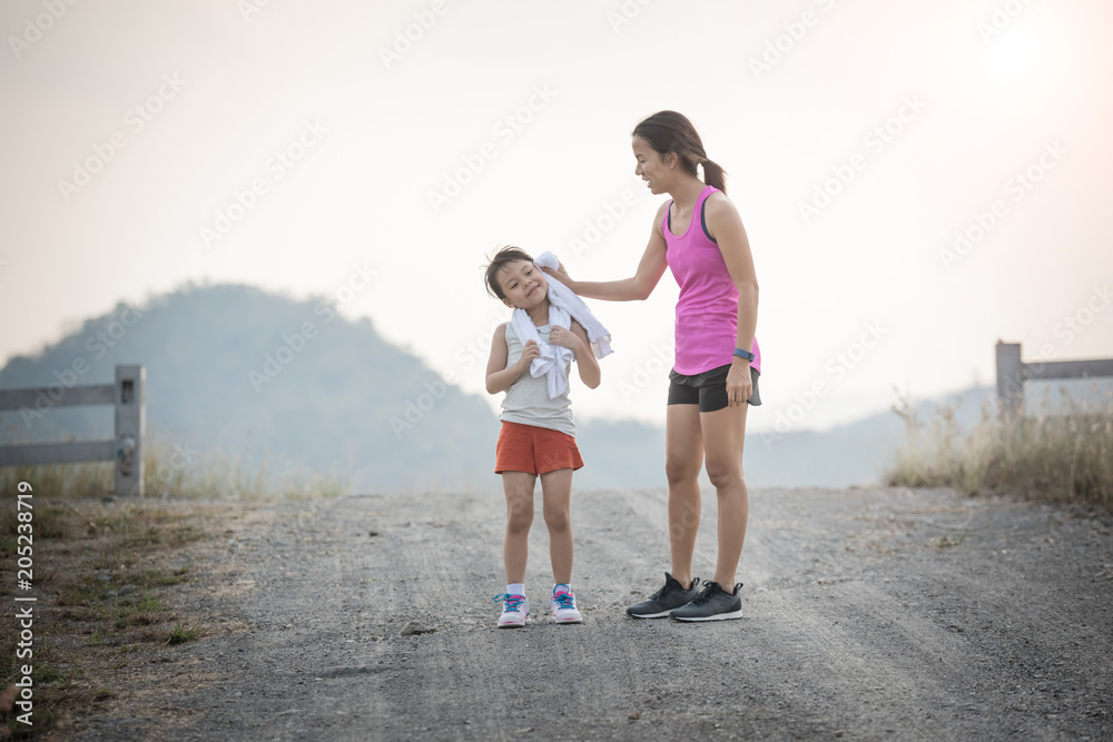 mother and her daughter running on the road in the countryside, sports, healthy lifestyle mother and her daughter running on the road in the countryside, sports, healthy lifestyle