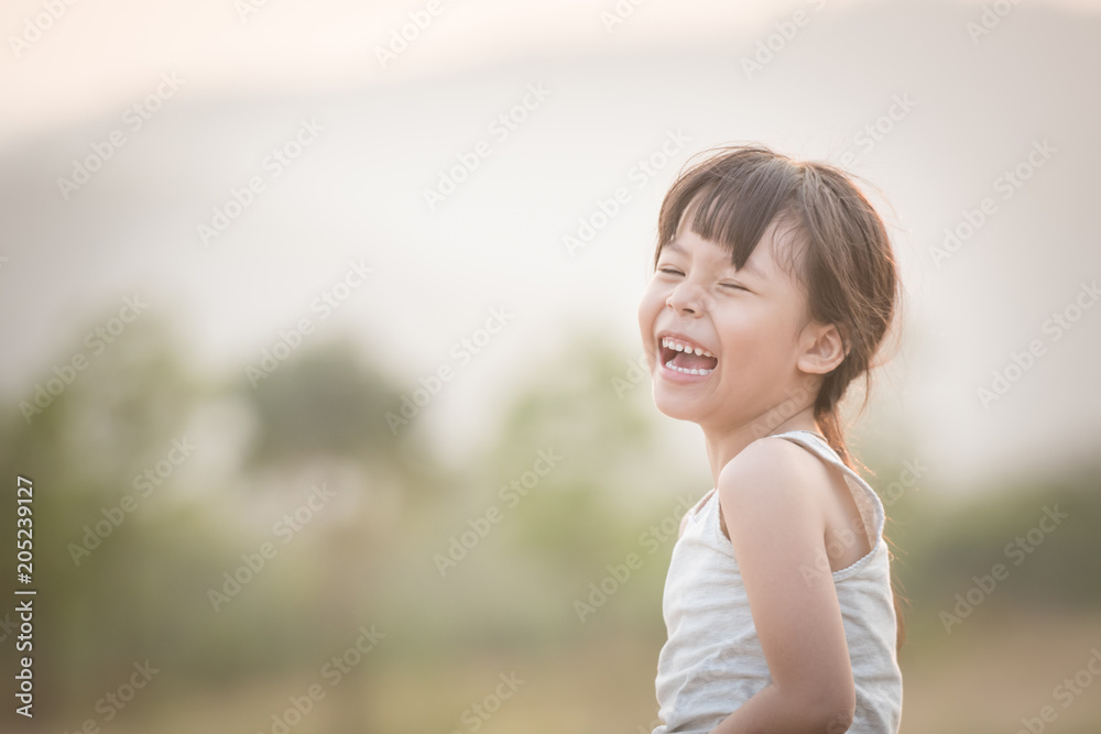 happy child girl playing on sunny field, summer outdoor lifestyle, cozy mood