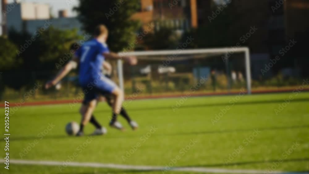 Players try to take away the ball in slow motion, blurred Players try to take away the ball in slow motion, blurred
