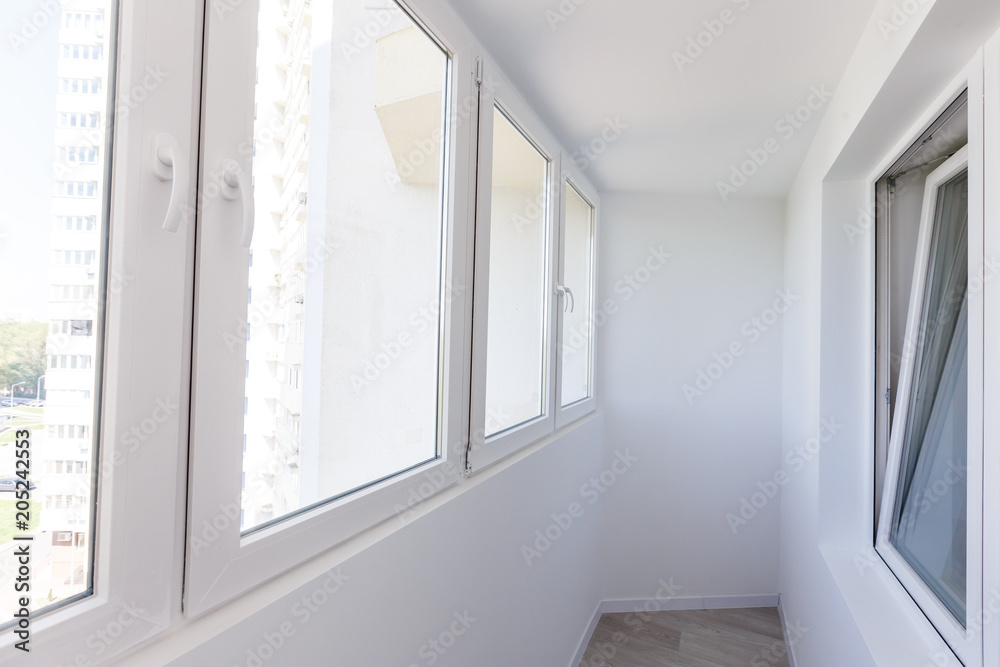 White metal-plastic windows of balcony in modern apartment White metal-plastic windows of balcony in modern apartment