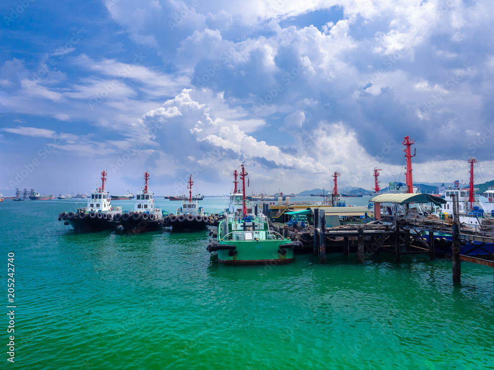 The tug boats alongside at pier stationed in the gulf of  Thailand Port.