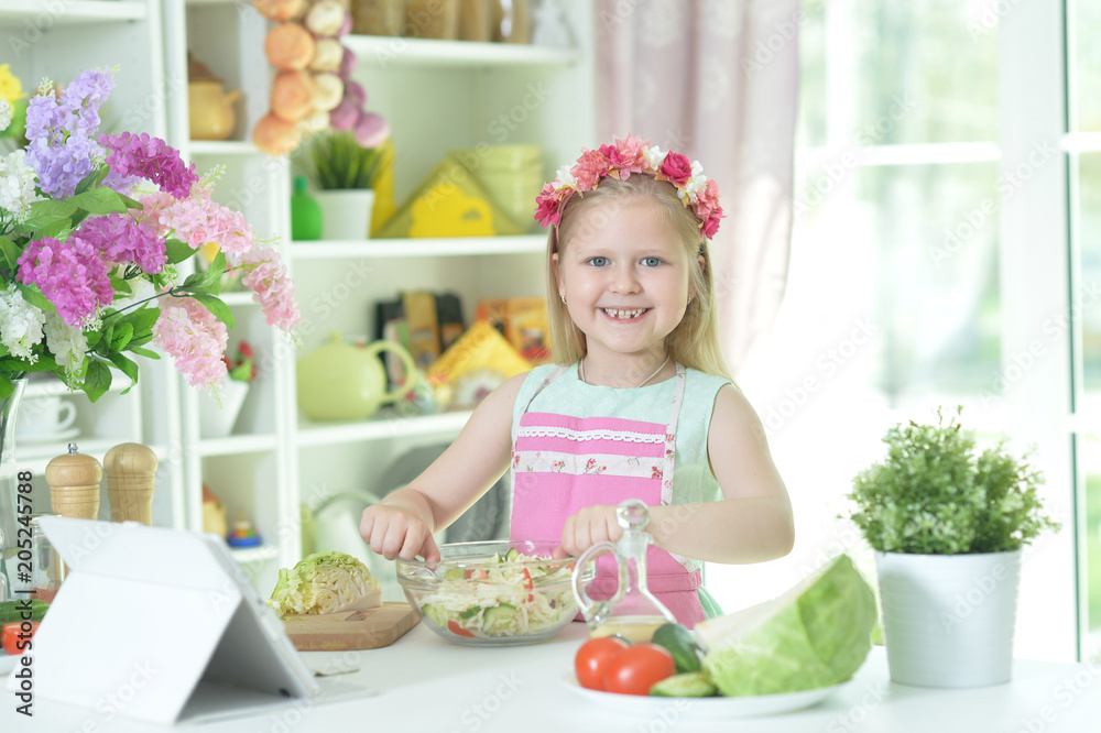 Cute little girl making dinner